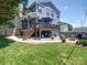 Expansive backyard featuring a deck, outdoor seating, a fire pit, and well-maintained lawn at 1421 Lyon Ct, Charlotte, NC 28205