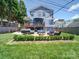 Charming two-story home showcasing a backyard with a deck, a patio, and a fire pit for outdoor enjoyment at 1421 Lyon Ct, Charlotte, NC 28205
