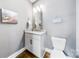 Well-lit powder room featuring a granite countertop vanity and modern fixtures at 1421 Lyon Ct, Charlotte, NC 28205