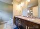 Bright bathroom features a double vanity with granite countertop and decorative lighting at 1421 Lyon Ct, Charlotte, NC 28205