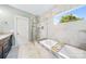 Spa-like bathroom with a soaking tub, walk-in shower, and elegant tile work at 1421 Lyon Ct, Charlotte, NC 28205