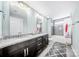 Modern bathroom with double vanity, granite countertops, and a shower-tub combo with stylish gray tiling at 1421 Lyon Ct, Charlotte, NC 28205