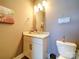 A cozy powder room featuring a neutral color scheme and classic finishes at 1421 Lyon Ct, Charlotte, NC 28205