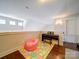 Bright bonus room with hardwood floors, a play area and a keyboard offers flexible space at 1421 Lyon Ct, Charlotte, NC 28205