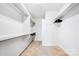 Spacious walk-in closet with ample shelving and hanging space for organized storage at 1421 Lyon Ct, Charlotte, NC 28205