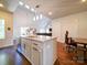 Open kitchen with oversized island, stainless appliances, and hardwood floors at 1421 Lyon Ct, Charlotte, NC 28205