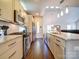 Open kitchen with granite counters, stainless appliances, and hardwood floors flows into the living space at 1421 Lyon Ct, Charlotte, NC 28205