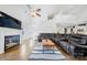 Inviting living room with a fireplace, modern ceiling fan, and a large sectional for relaxation at 1421 Lyon Ct, Charlotte, NC 28205