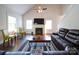 Spacious living room with a cozy fireplace, large windows, and comfortable seating for relaxation at 1421 Lyon Ct, Charlotte, NC 28205