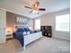 Cozy bedroom features a white bed, a ceiling fan, and soft carpet, creating a relaxing atmosphere at 1421 Lyon Ct, Charlotte, NC 28205