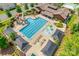 Aerial view of community pool with sunbathing area, shade structures, and playground at 1446 Cilantro Ct, Tega Cay, SC 29708