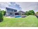 Expansive backyard with kidney-shaped pool, lawn and partial fence surround at 1446 Cilantro Ct, Tega Cay, SC 29708