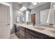 Bathroom featuring double sinks, granite countertop, and vanity mirror at 1446 Cilantro Ct, Tega Cay, SC 29708