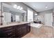 Well lit bathroom with double vanity, garden tub and walk-in shower at 1446 Cilantro Ct, Tega Cay, SC 29708