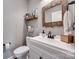 Charming half bathroom with rustic mirror and white wainscoting at 1446 Cilantro Ct, Tega Cay, SC 29708