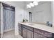 Bathroom with granite countertop, double sinks, and a shower at 1446 Cilantro Ct, Tega Cay, SC 29708