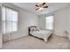 Bedroom featuring a ceiling fan, carpeted floors and floral curtains at 1446 Cilantro Ct, Tega Cay, SC 29708