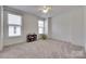 Bright bedroom featuring two large windows and neutral carpet at 1446 Cilantro Ct, Tega Cay, SC 29708