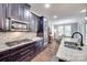 Modern kitchen with dark wood cabinetry, granite countertops, and stainless steel appliances at 1446 Cilantro Ct, Fort Mill, SC 29708