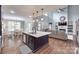 Open-concept kitchen featuring a large island, stainless steel appliances, and hardwood floors at 1446 Cilantro Ct, Tega Cay, SC 29708