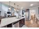 Open-concept kitchen with a granite island, stainless appliances, and views of the living room at 1446 Cilantro Ct, Tega Cay, SC 29708