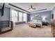 Spacious primary bedroom with tray ceilings, carpet, and large windows offering great natural light at 1446 Cilantro Ct, Tega Cay, SC 29708