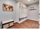 Mudroom with hardwood floors, built in shelving units and a wooden world map wall decoration at 1446 Cilantro Ct, Tega Cay, SC 29708
