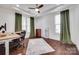 Well-lit office space featuring hardwood floors, a ceiling fan, and large windows at 1446 Cilantro Ct, Tega Cay, SC 29708