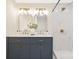 Bathroom featuring a modern vanity, dual sinks, gold fixtures and a shower with stunning marble tile at 145 Burton Hills Cir, Gastonia, NC 28054