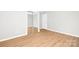 Spacious bedroom features mirrored closet doors and wood-look flooring, offering style and functionality at 145 Burton Hills Cir, Gastonia, NC 28054