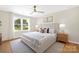 Comfortable bedroom boasts a large window, ceiling fan, and a plush king-size bed for peaceful nights at 145 Burton Hills Cir, Gastonia, NC 28054