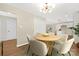 Bright dining area features a round table, modern light fixture, and easy access to the kitchen for convenient dining at 145 Burton Hills Cir, Gastonia, NC 28054