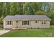Charming single-story home with a well-manicured lawn and neutral-toned brick and vinyl siding at 145 Burton Hills Cir, Gastonia, NC 28054