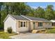 A cozy home featuring neutral-toned brick and vinyl siding, complemented by a well-maintained lawn and wood shutters at 145 Burton Hills Cir, Gastonia, NC 28054