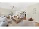 Bright, open-concept living space with hardwood floors, modern furnishings, and a view into the stylish kitchen at 145 Burton Hills Cir, Gastonia, NC 28054