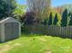Storage shed in the backyard offers practical space with mature landscaping and sunny lawn at 15326 Carrington Ridge Dr, Huntersville, NC 28078