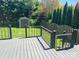 Wood deck overlooks lush backyard with shed providing outdoor storage with black metal railing at 15326 Carrington Ridge Dr, Huntersville, NC 28078