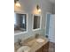 Bathroom features a double vanity with granite counters, framed mirrors and modern lighting fixtures at 15326 Carrington Ridge Dr, Huntersville, NC 28078