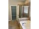 Bathroom showcasing a tub with tiled surround, glass shower, and access to a walk-in closet at 15326 Carrington Ridge Dr, Huntersville, NC 28078