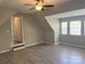 Bedroom with wood-look floors, angled ceilings, recessed lighting, and access to the hallway at 15326 Carrington Ridge Dr, Huntersville, NC 28078