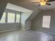 Bedroom boasts wood-look floors, natural light from multiple windows, and a ceiling fan at 15326 Carrington Ridge Dr, Huntersville, NC 28078