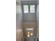 Bright, two-story foyer with hardwood floors and a view of the front door at 15326 Carrington Ridge Dr, Huntersville, NC 28078