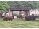 Wooden gazebo featuring swing bench seating, and manicured shrubs in a common neighborhood grassy area at 15326 Carrington Ridge Dr, Huntersville, NC 28078