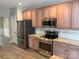 Beautiful kitchen featuring granite countertops, stainless steel appliances, and freshly painted cabinets at 15326 Carrington Ridge Dr, Huntersville, NC 28078