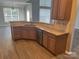 Modern kitchen showcasing granite countertops, stainless steel dishwasher, and wood cabinetry at 15326 Carrington Ridge Dr, Huntersville, NC 28078