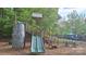 Large playground with climbing structure, slides, picnic table, and sunshade in a mulched play area at 15326 Carrington Ridge Dr, Huntersville, NC 28078