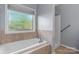 Bathroom showcasing a soaking tub, separate shower, and window at 1618 33Rd Ne Ave # 1, Hickory, NC 28601
