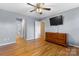 Bedroom featuring hardwood floors, a ceiling fan, TV, and wood dresser at 1618 33Rd Ne Ave # 1, Hickory, NC 28601