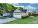 Low-angle view of a well-maintained house with a wide driveway and lush green lawn at 1618 33Rd Ne Ave # 1, Hickory, NC 28601