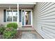 Inviting entryway with a blue front door and brick accents, framed by a landscaped garden at 1618 33Rd Ne Ave # 1, Hickory, NC 28601